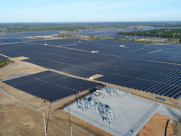 Utility-scale solar field with an electrical substation in the foreground